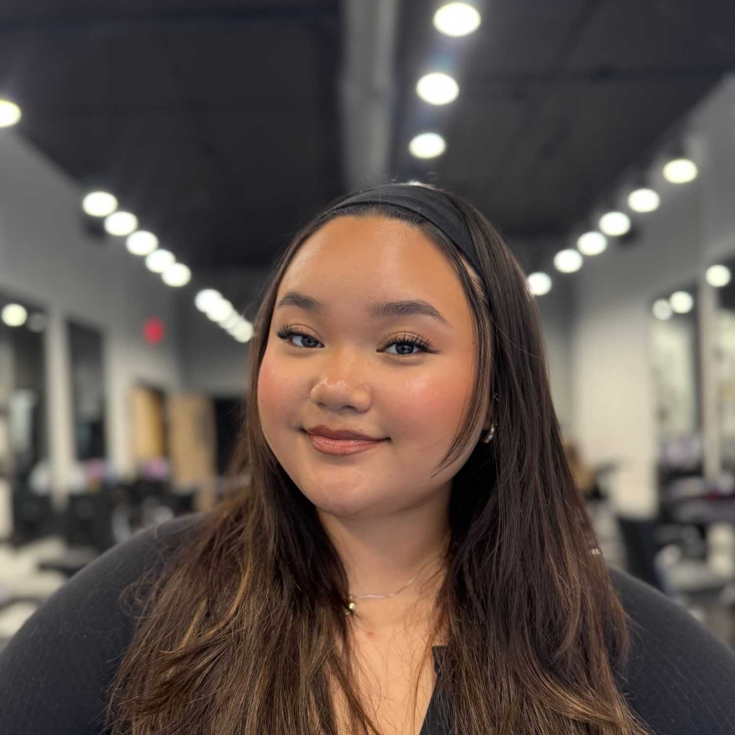 Portrait of Crystabelle Sidi, a professional stylist at Jason Matthew Salon, showcasing their expertise and style.