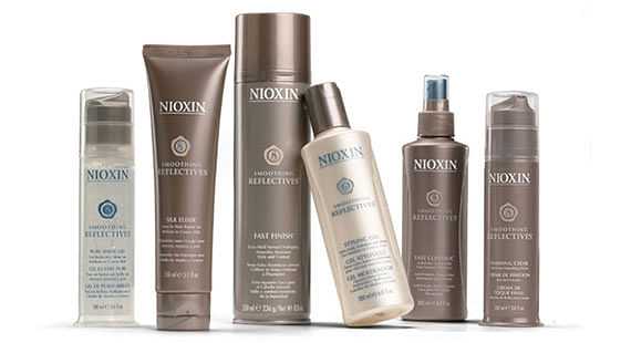 Nioxin hair products including shampoo, conditioner, and styling sprays arranged side by side.