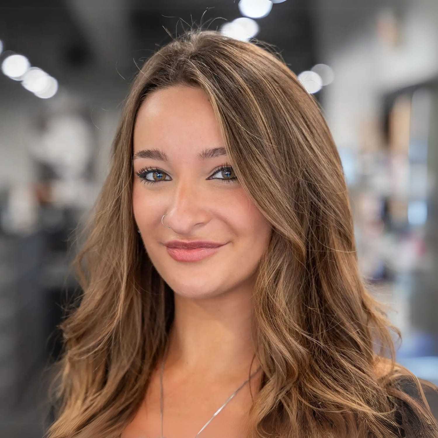 Portrait of Nora Scott, a professional stylist at Jason Matthew Salon, showcasing their expertise and style.